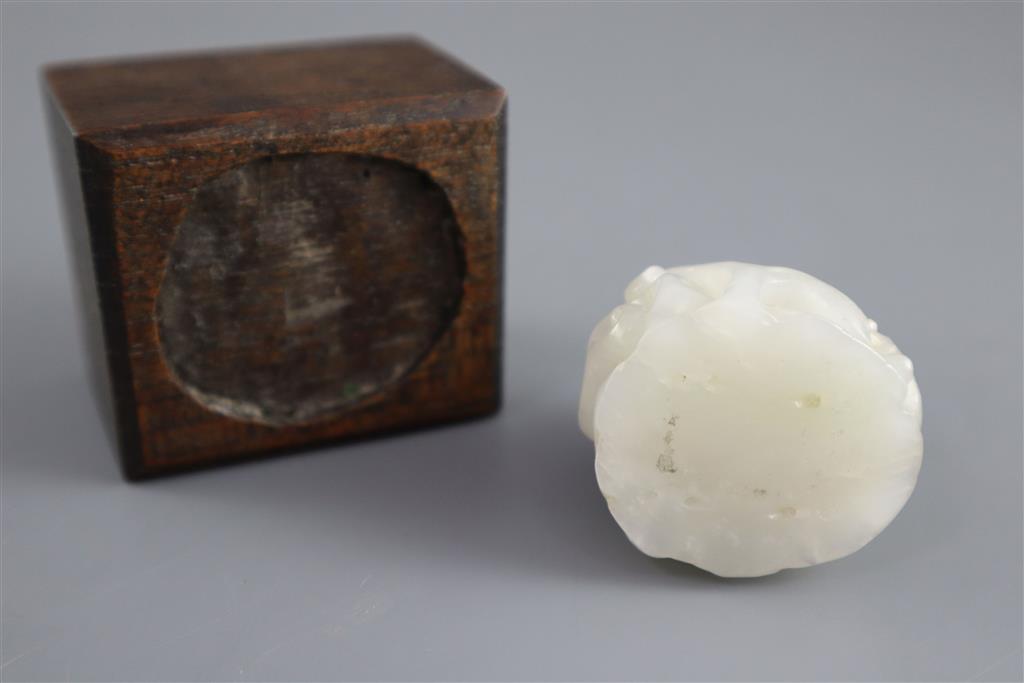 A Chinese white jade hat finial, 3.8cm high, later wood stand